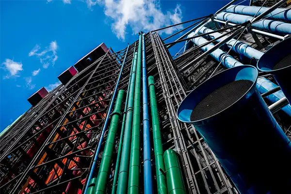 Colored pipes on Centre Goerge Pompidou in Paris under blue sky with small clouds